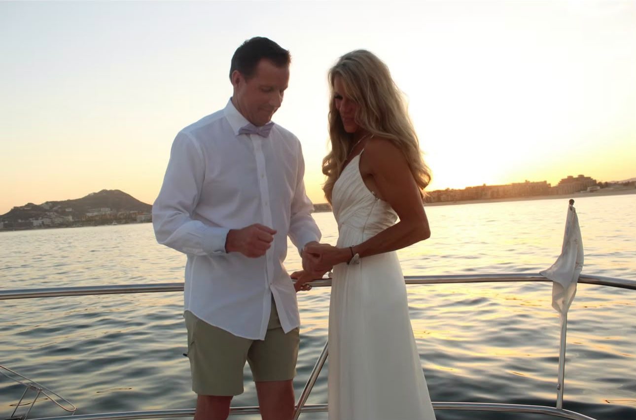 Couple on the deck of Cabo2Vegas during a sunset marriage proposal